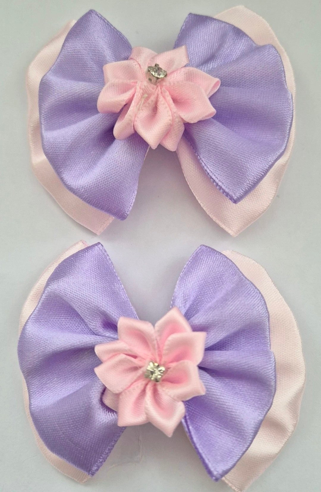 A pair of Lilac and Pink hair bows